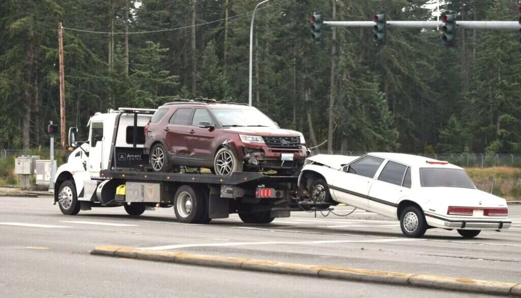 Amani Towing flatbed tow truck on a Birmingham road