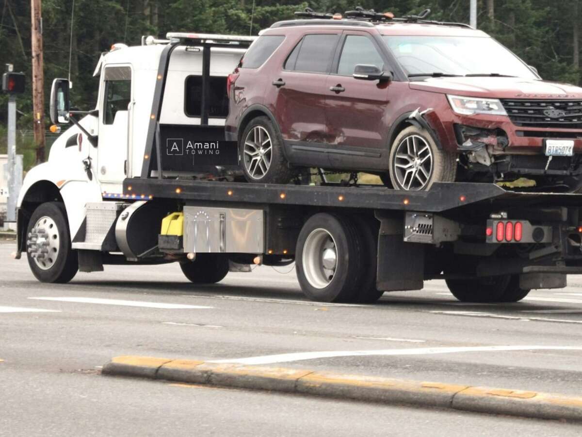 Amani Towing flatbed tow truck transporting a customer vehicle in Birmingham